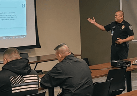 Security officer giving a presentation to a group of attendees