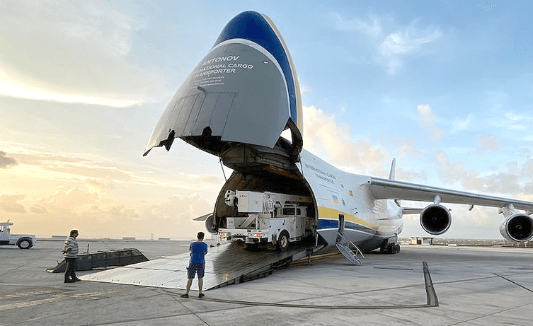 Cargo being loaded into a large transport aircraft with its nose lifted