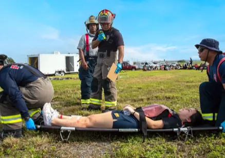 Emergency responders assisting an injured person on a stretcher